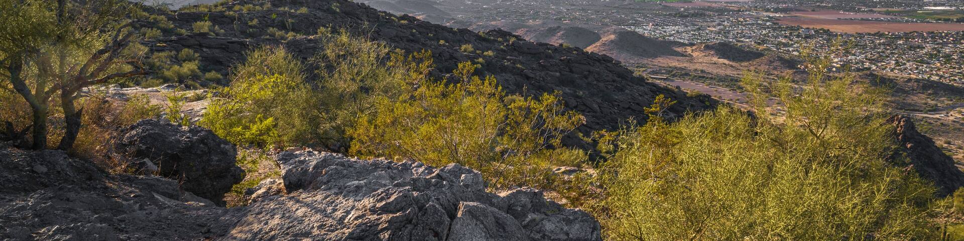 Haze over the desert mountain hills in South Mountain and Preserve Public Park in Phoenix, Arizona at sunset