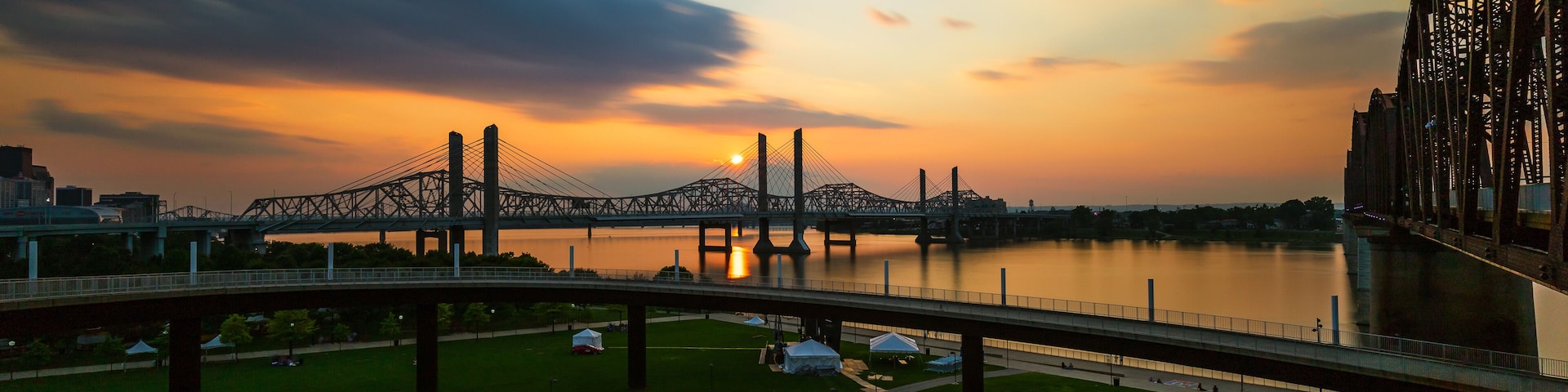 The Abraham Lincoln Bridge crosses the Ohio River that connects Kentucky and Indiana for motor vehicles. Long exposure sky and water movement.