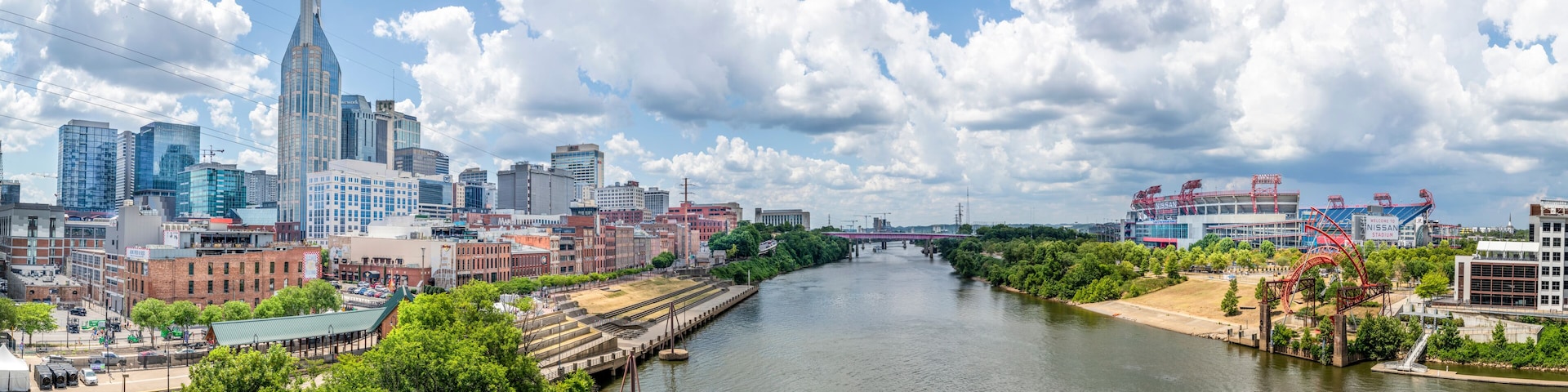 A river flowing through a city with modern buildings and a bridge.
