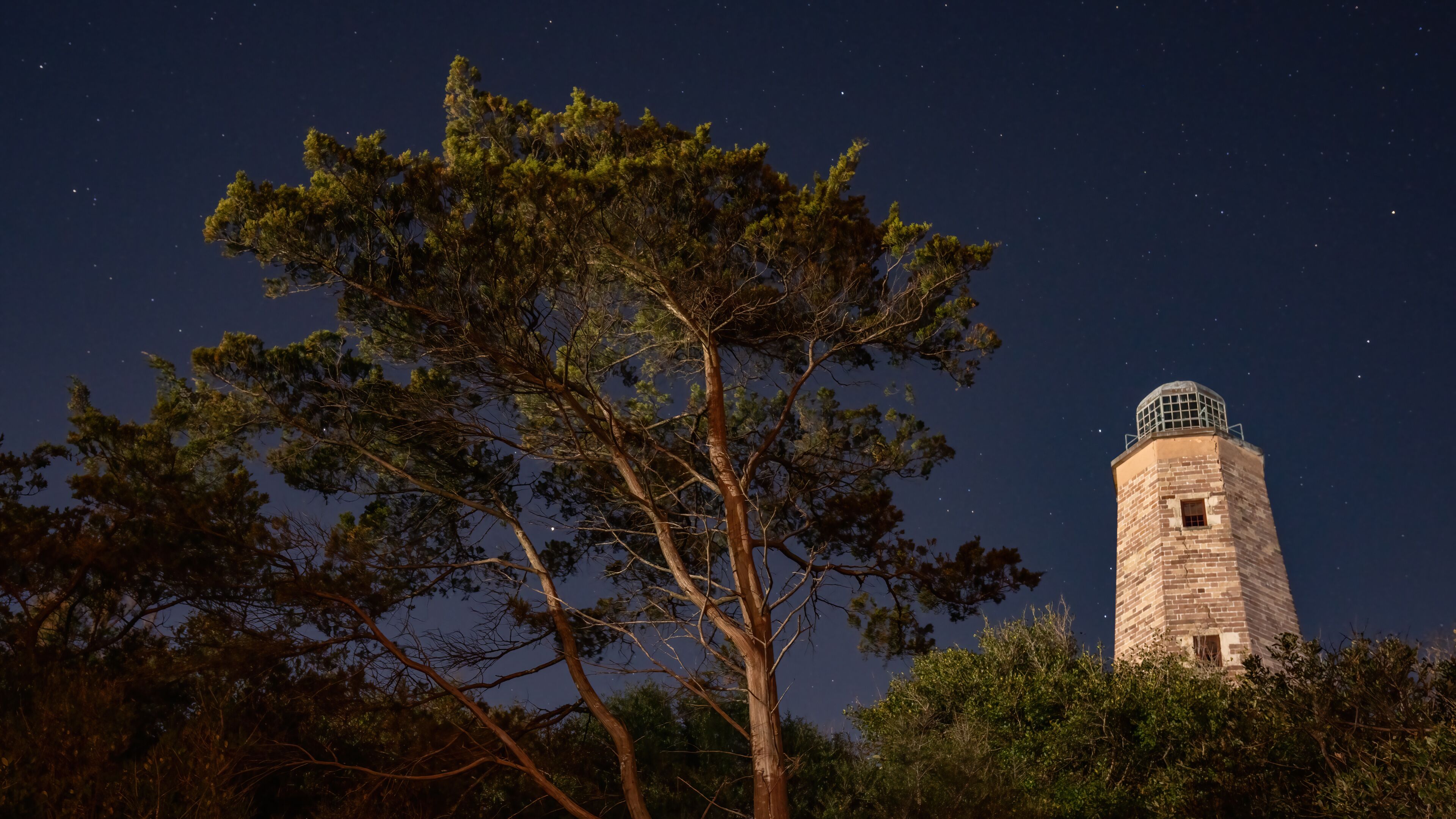 Cape Henry Lighthouse in Fort Story Virginia at night.  Both the old and new lighthouse.