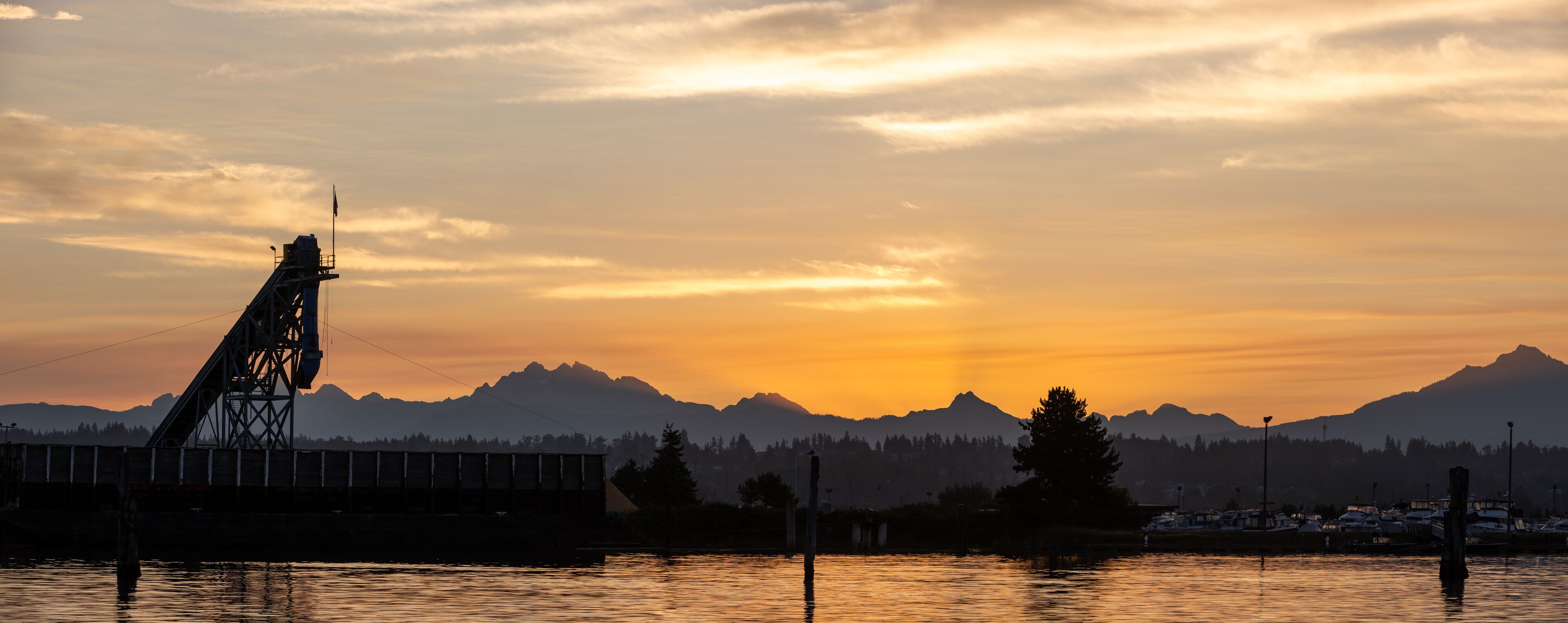 Crane loading barge at dawn