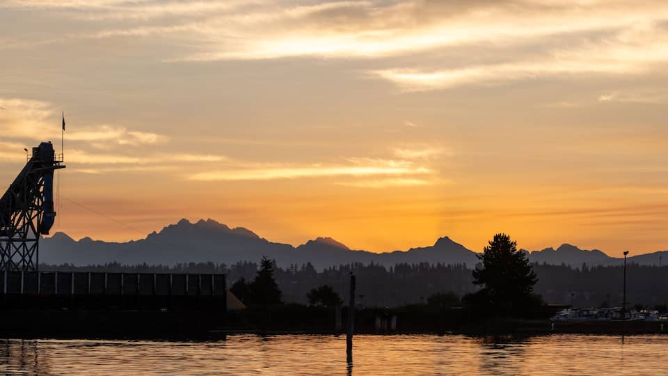 Crane loading barge at dawn