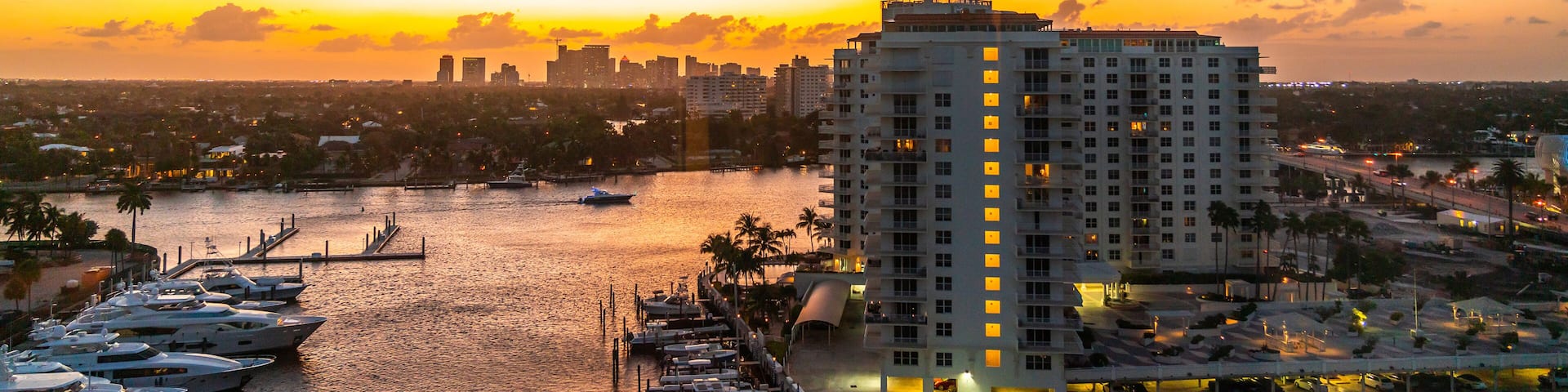 Aerial view of Fort Lauderdale waterway canals, residential homes and skyline at sunset