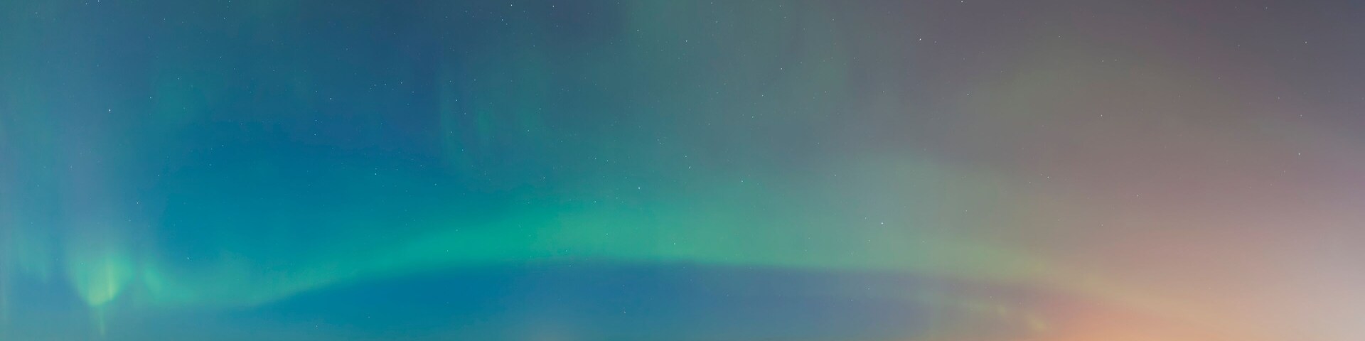 The northern lights shine above the anchorage city skyline in this nighttime view from the tony knowles coastal trail in winter; Anchorage alaska united states of america