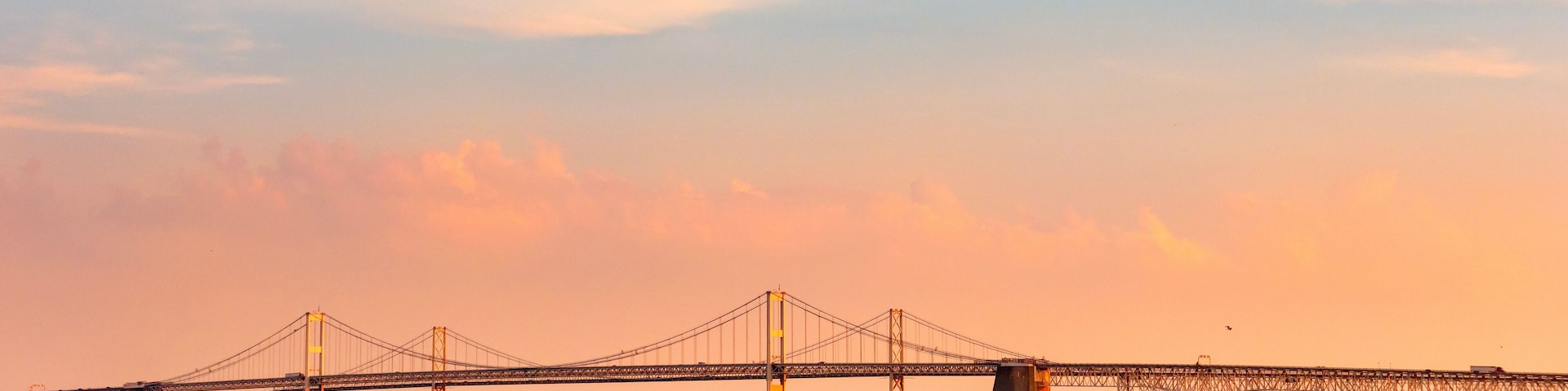 Chesapeake Bay Bridge with blue and orange sunset