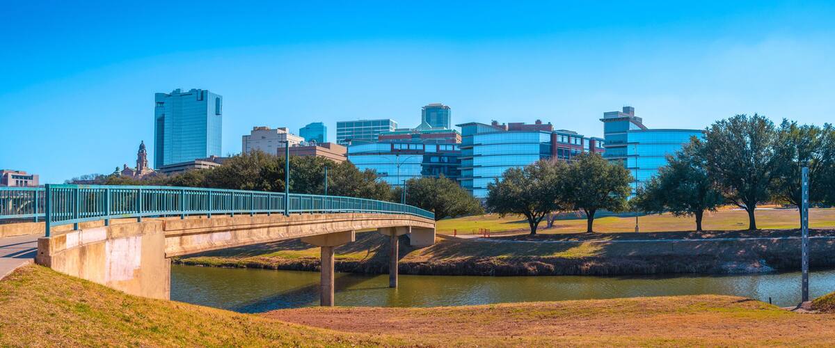 Fort Worth panoramic city skyline and building architecture over Trinity River, cityscape with natural open space and trails