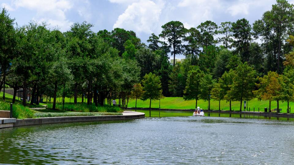 the Woodlands Waterway with swan paddle boat in background