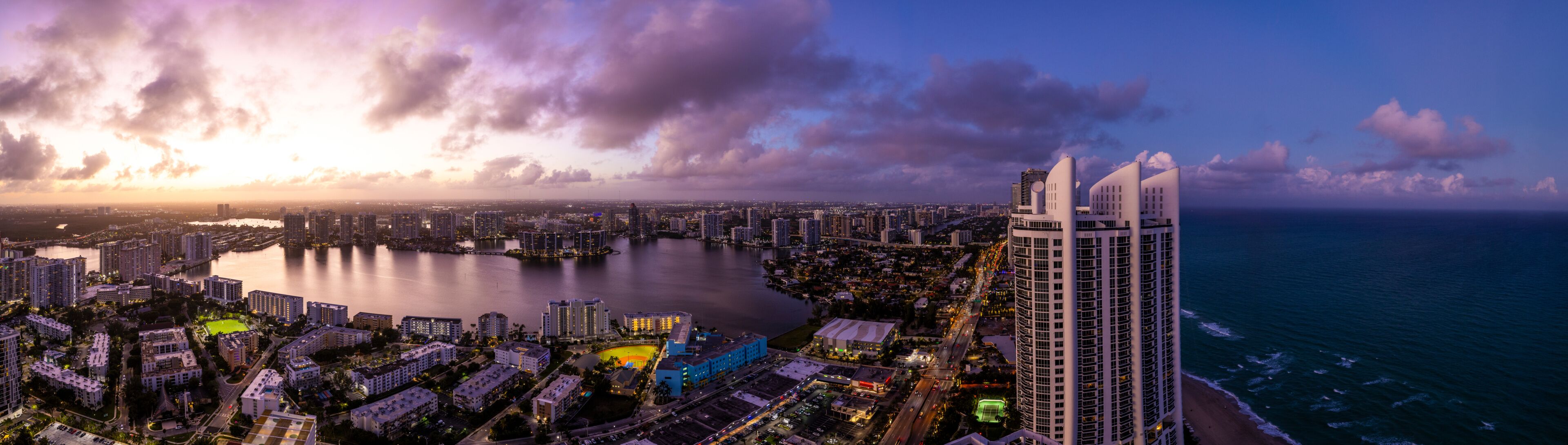 Aerial view of beautiful Dumfoundling Bay with a stunning skyline of high-rise buildings at sunset, Aventura, Florida, USA.