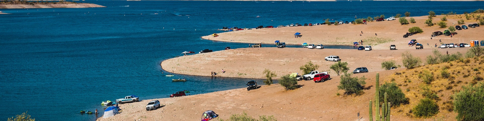 Cars parked on the banks of Lake Pleasant near Phoenix, Arizona, on a sunny day
