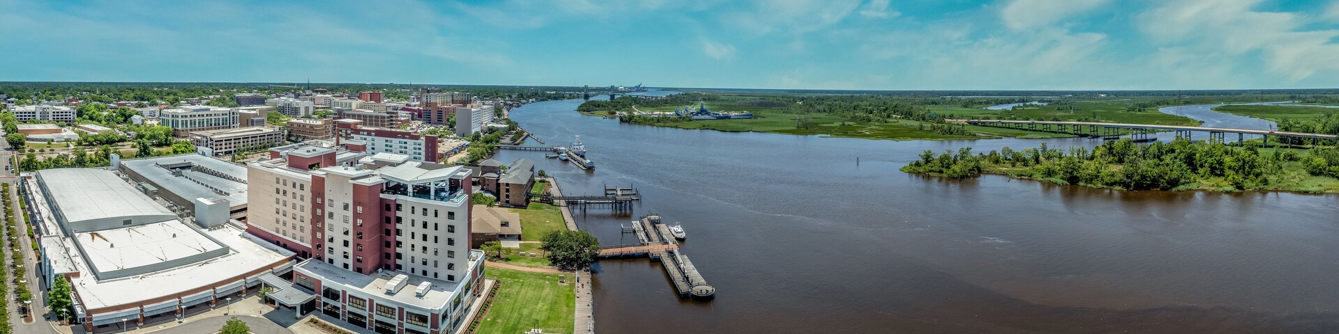 Aerial view of Wilmington North Carolina historic district along the Cape Fear river with cloudy sky