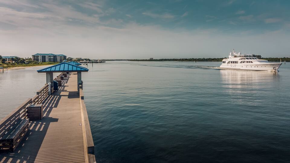 Smyrna Dunes Fishing Pier with Yacht in New Smyrna Beach, Florida