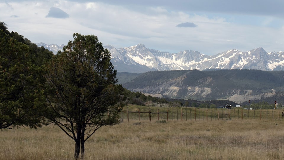 Ultra-wide panoramic view from Ridgway State Park of the San Juan Mountains on a stormy day in spring