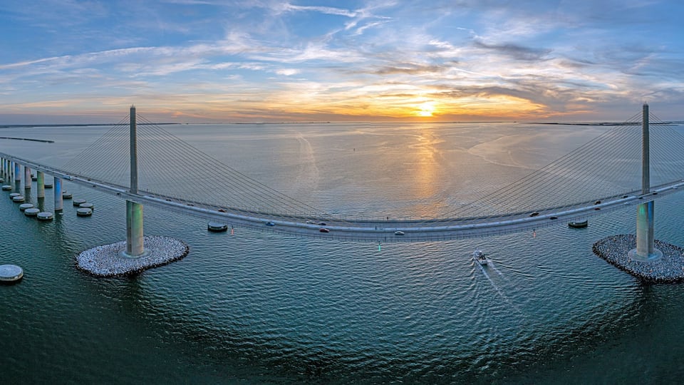 Drone panorama of Sunshine Skyway Bridge over Tampa Bay at sunset