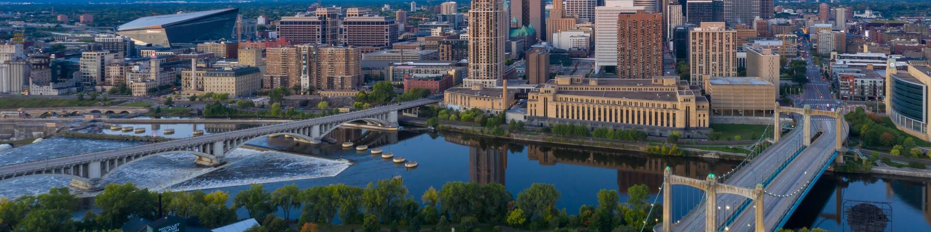 Aerial view of Minneapolis skyline at dawn, showcasing the city's architecture, bridges, and the Mississippi River. Urban landscape. Nicollet Island, Minneapolis, Minnesota, United States