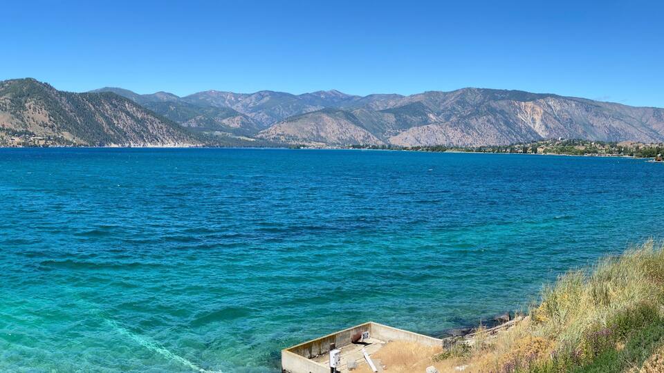A Lake Chelan panoramic landscape showing the incredible blue of the lake with the contrast of the arid hills in the background and a beautiful early summer day_20240623.