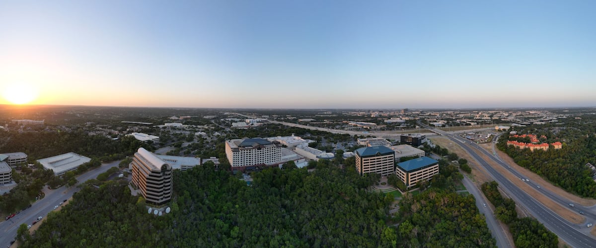 Sunset over the city and hill country. Clear blue skies. Orange sun. Vistas and panoramas.