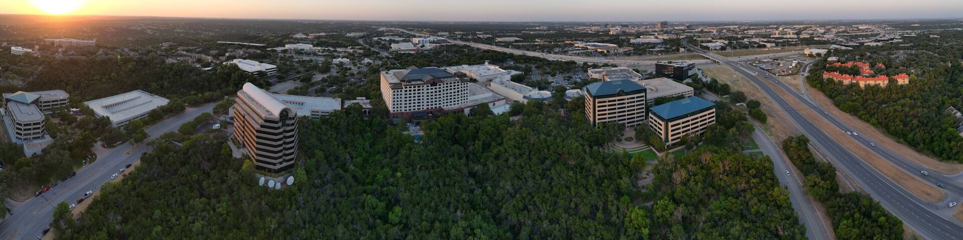 Sunset over the city and hill country. Clear blue skies. Orange sun. Vistas and panoramas.