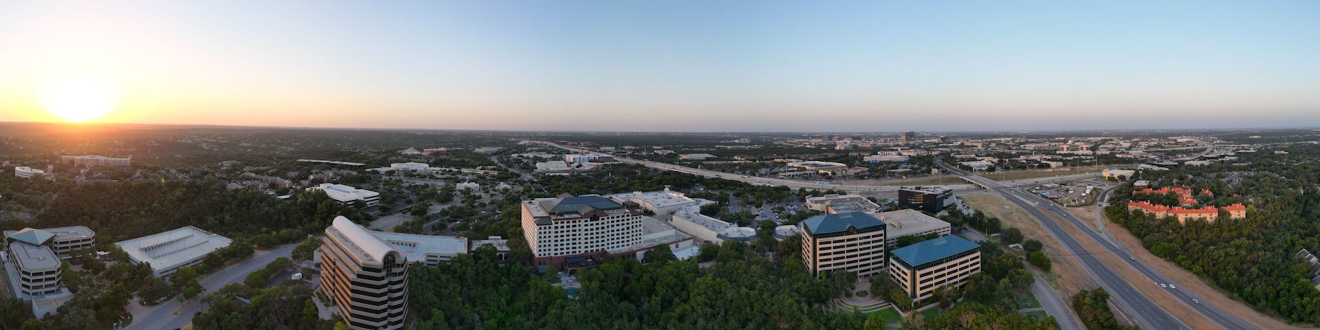 Sunset over the city and hill country. Clear blue skies. Orange sun. Vistas and panoramas.