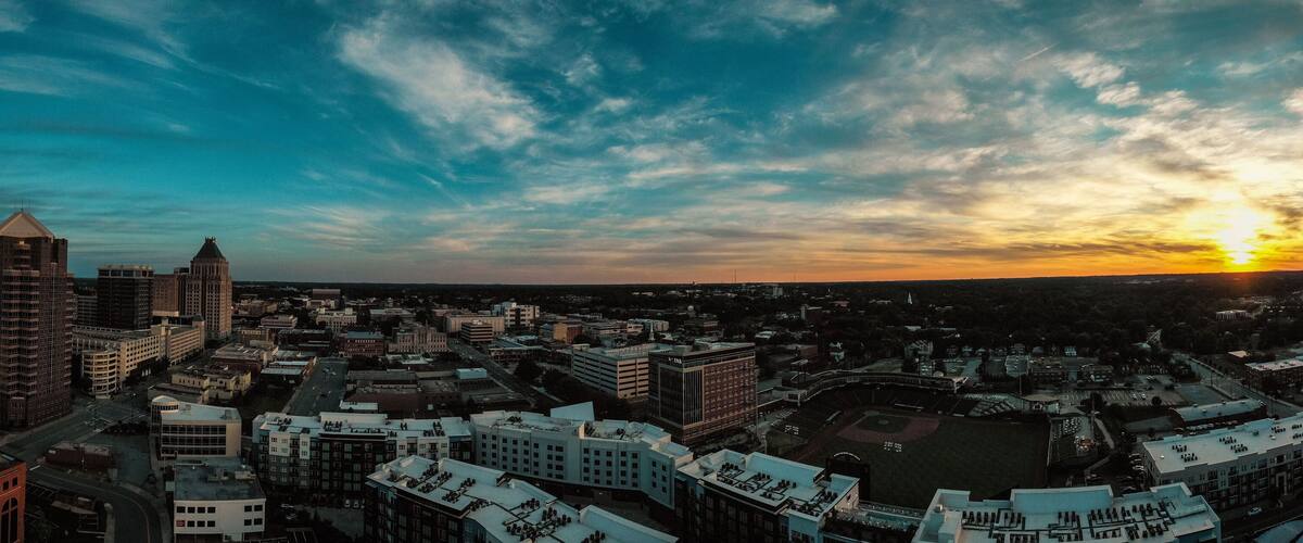 Panoramic view of the Greensboro, North Carolina skyline at sunset golden hour on Juneteenth