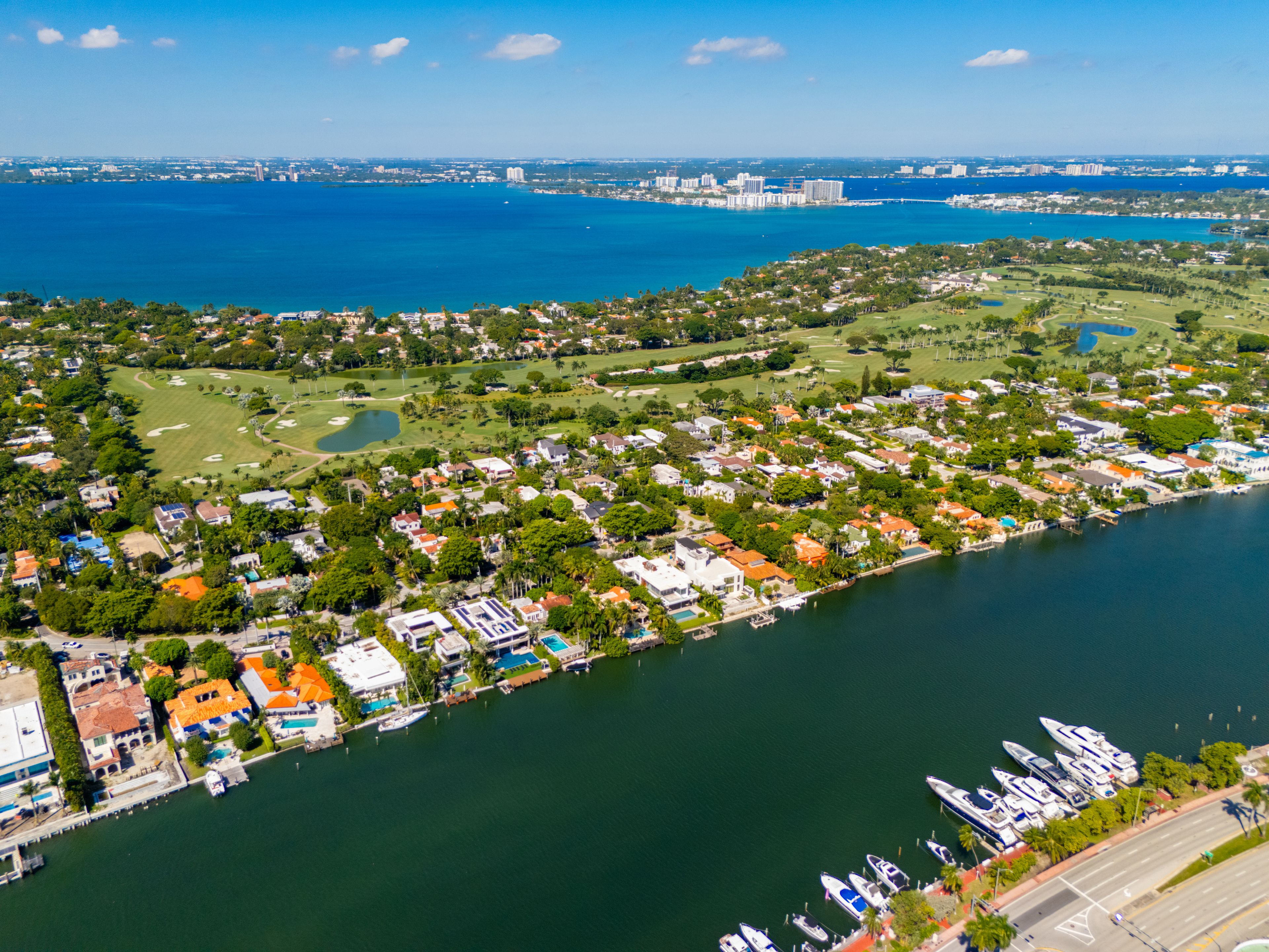 A coastal town with a marina, golf course, and residential areas.