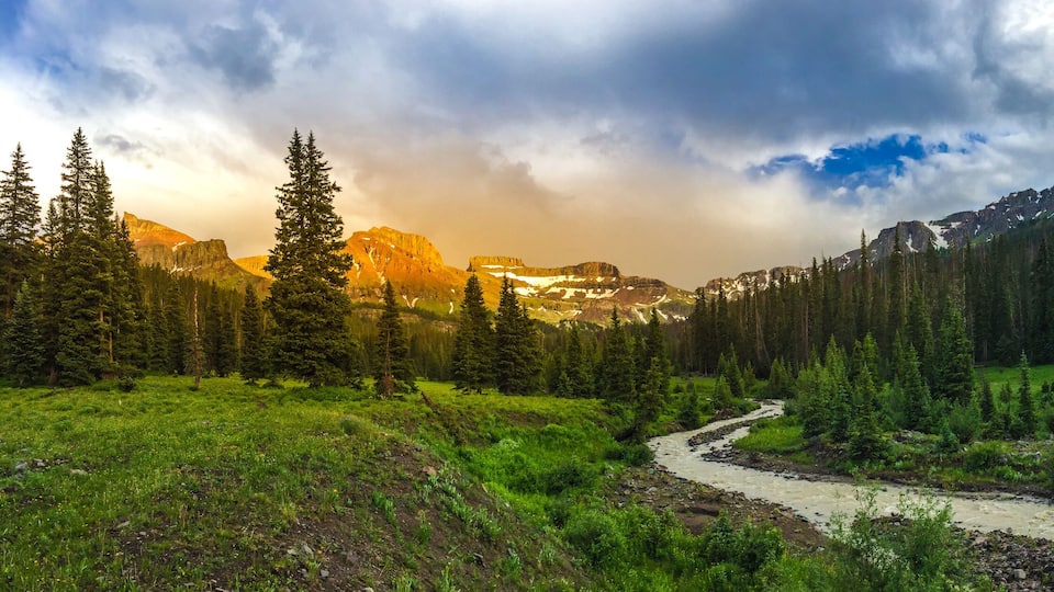 West Cimarron River with coxcomb redcliff and fortress mountains in the back at sunset