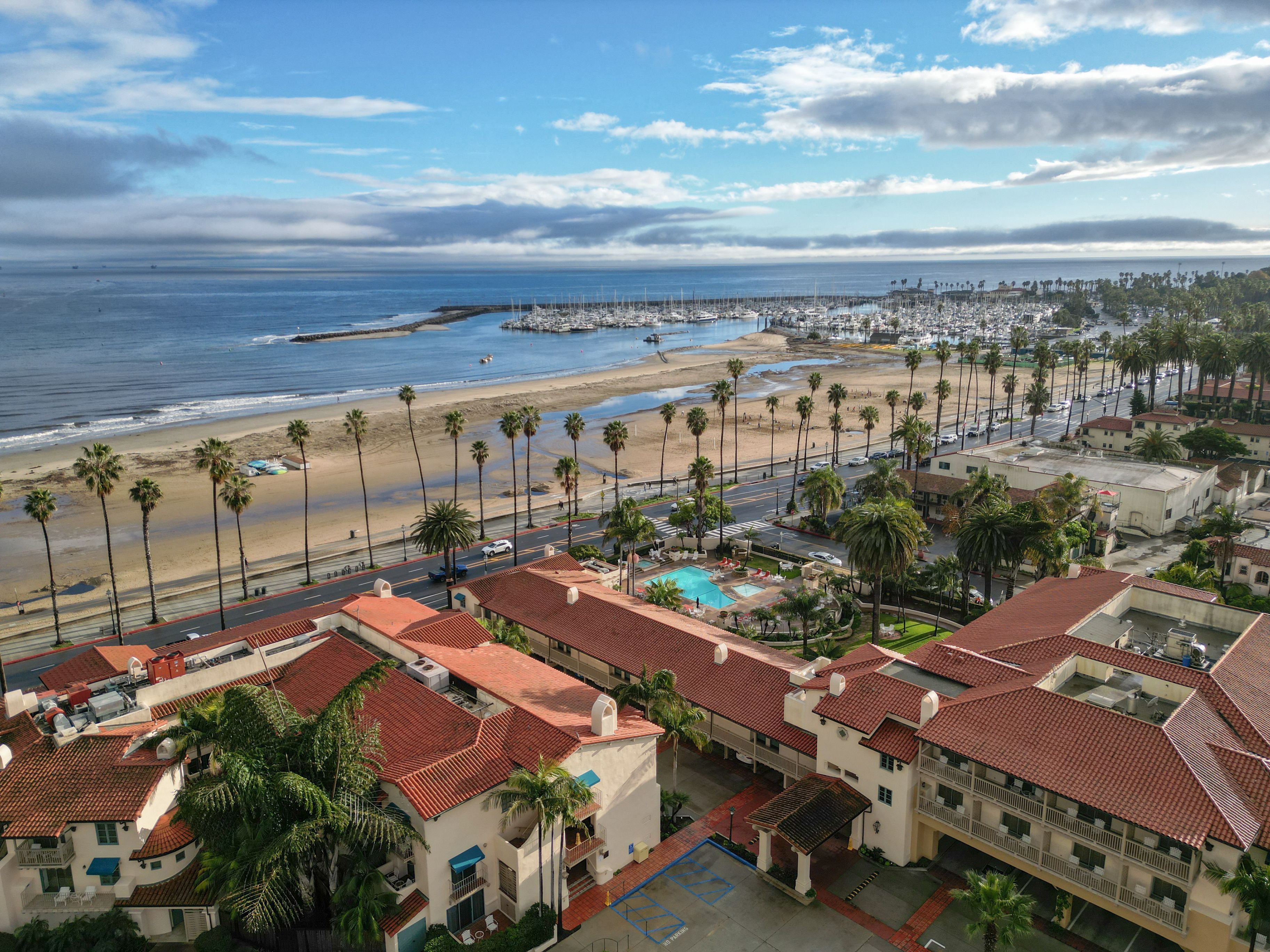 Aerial drone shot overlooking West Beach, Santa Barbara Harbor and Cabrillo Blvd. in Santa Barbara, California on a sunny afternoon.