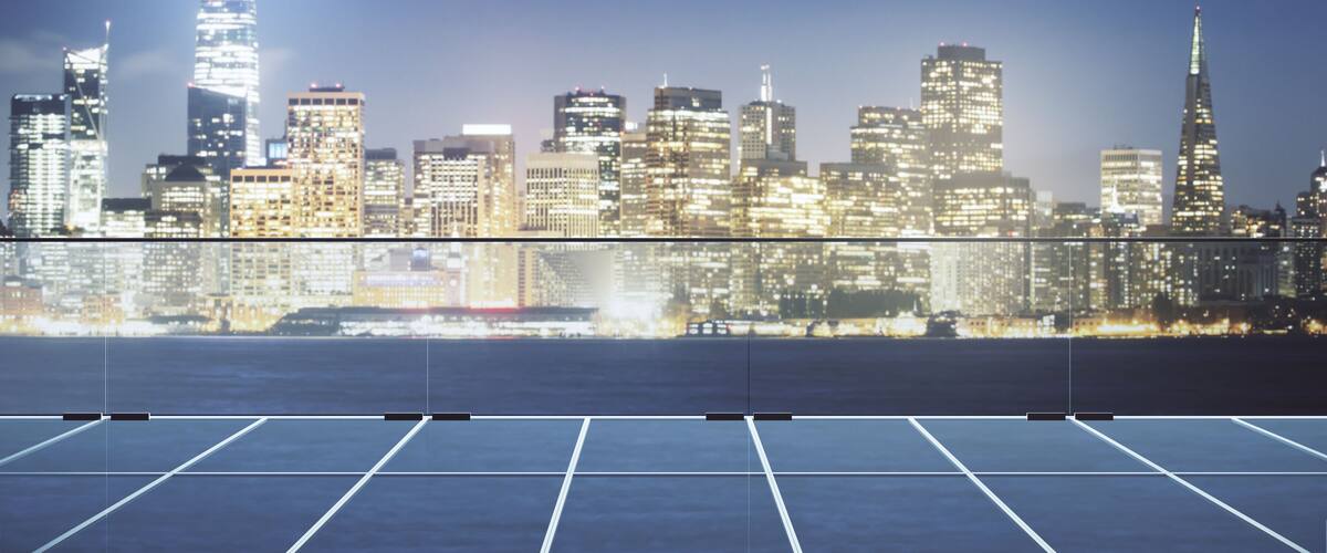 Modern glass roof of skyscraper on night cityscape background.