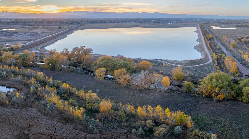 aerial panorama of Colorado landscape near Fort Collins with Poudre River, Rigden Reservoir and sunset over Rocky Mountains