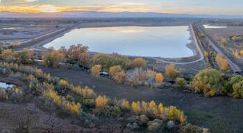 aerial panorama of Colorado landscape near Fort Collins with Poudre River, Rigden Reservoir and sunset over Rocky Mountains