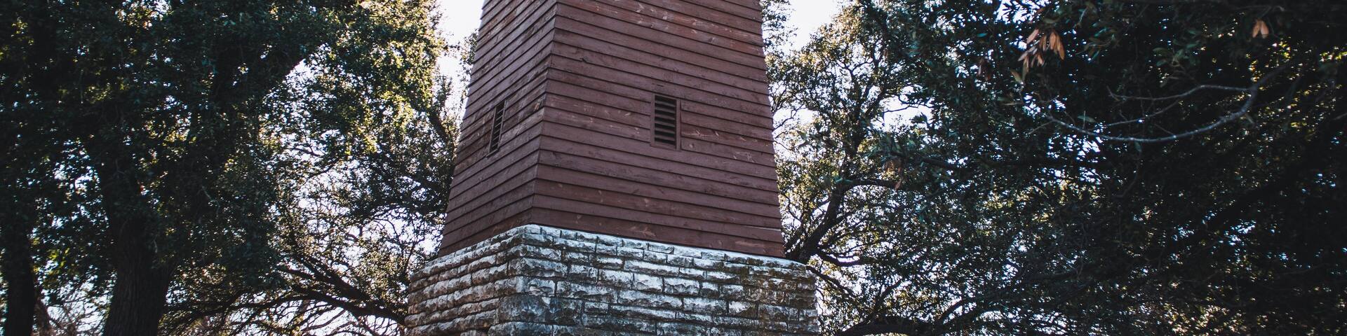 Historic water tower from the 1930s in a wooded area in the Abilene State Park in Texas, USA