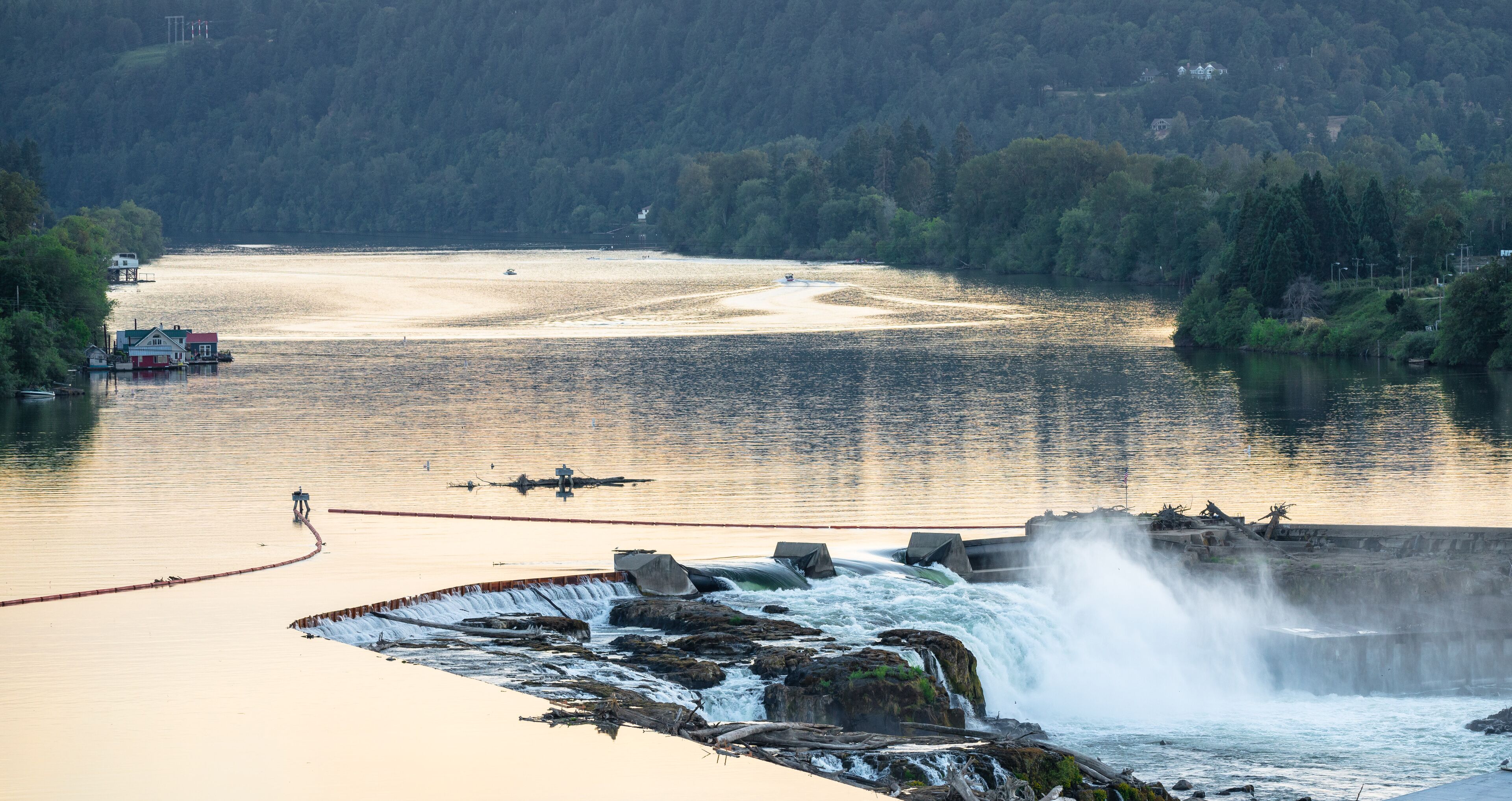 Willamette river at sunset with sun creating golden hue on the water.