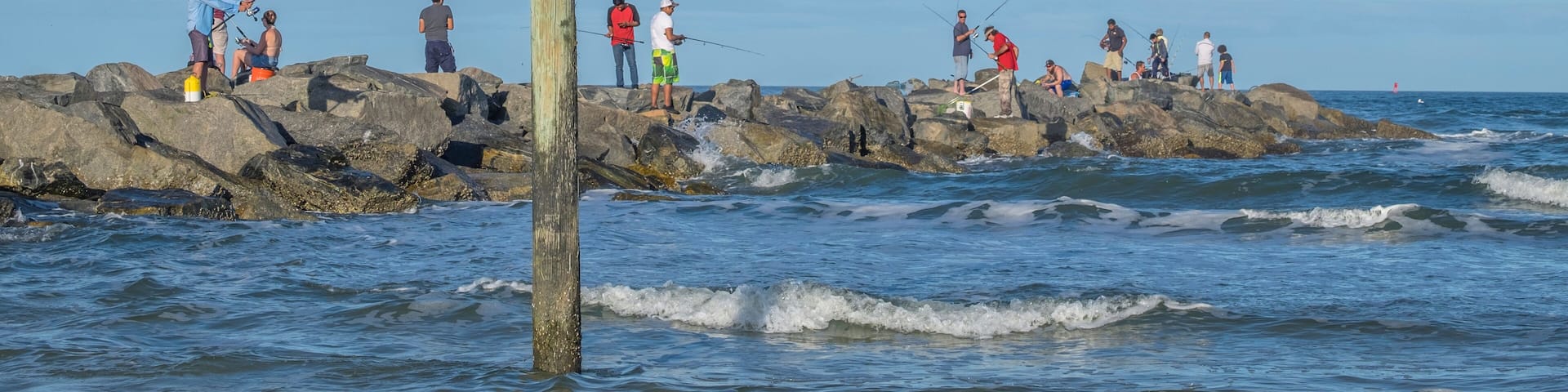 People fishing from jetty, New Smyrna Beach, Florida, Usa