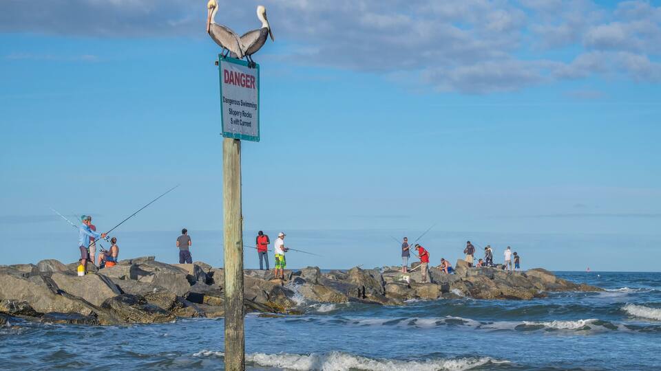 People fishing from jetty, New Smyrna Beach, Florida, Usa