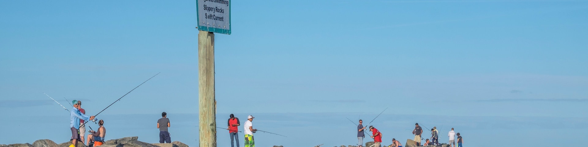 People fishing from jetty, New Smyrna Beach, Florida, Usa