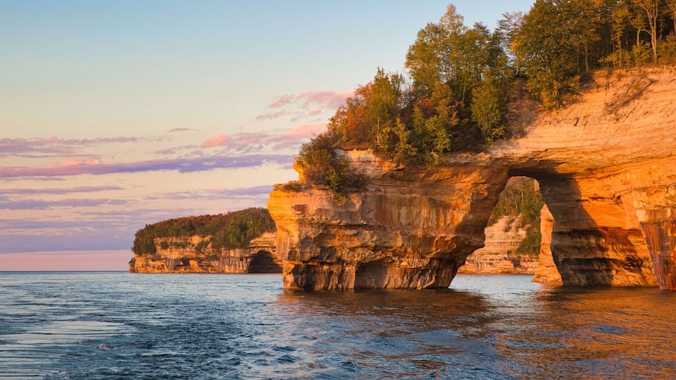 Lover's Leap Arch in Pictured Rocks National Lakeshore against scenic sunset