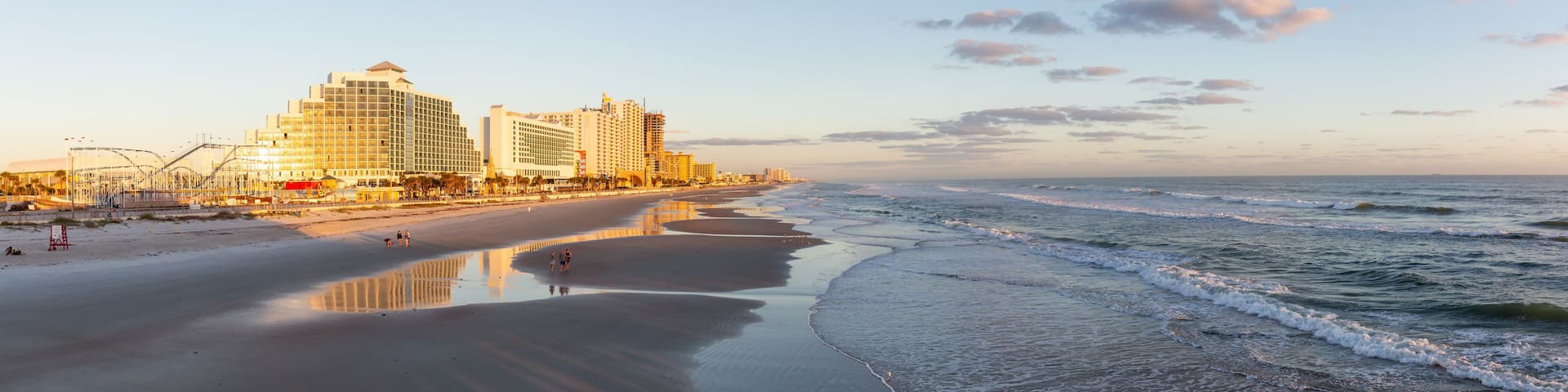 Daytona Beach, Florida, United States - October 31, 2018: Panoramic view of a beautiful sandy beach during a vibrant sunrise.