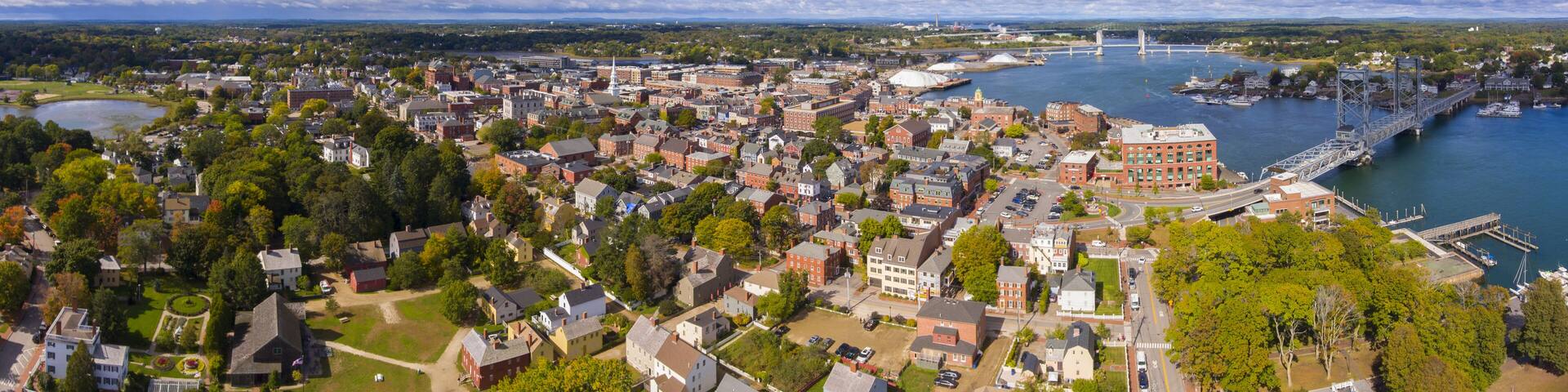 Portsmouth historic city center and Waterfront of Piscataqua River with Memorial Bridge panorama aerial view, New Hampshire, NH, USA.