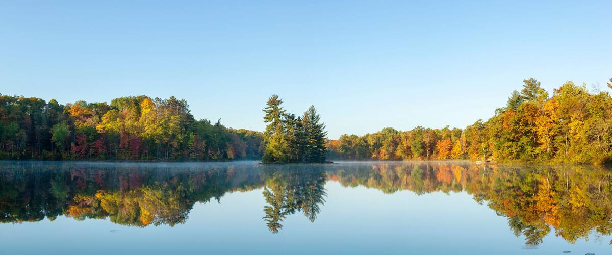 Panorama of beautiful calm lake in northern Minnesota on an autumn morning