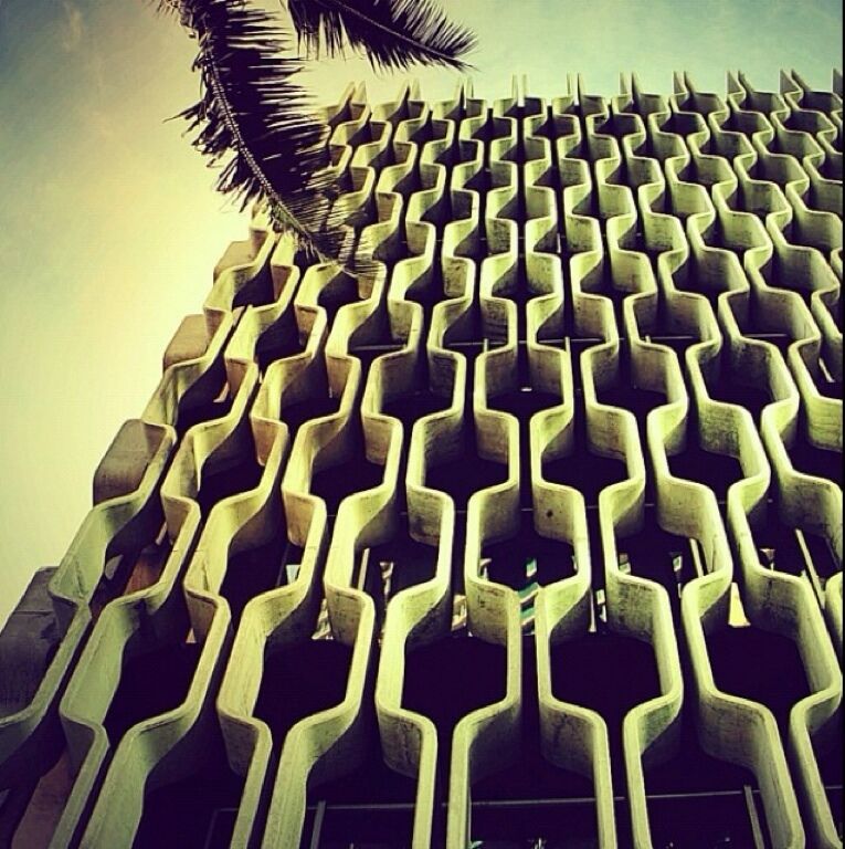 IBM Building (1962). Designed by Vladimir Ossipoff in 1962.  In a city filled with midcentury modern architecture The IBM Bldg stands apart as one of the most elegant examples. The concrete "grill" is meant to resemble both a typical Polynesian pattern and a computer punchcard.  It also serves the practical purpose of a sunscreen.  The unique shape makes it self-washing in the rain.