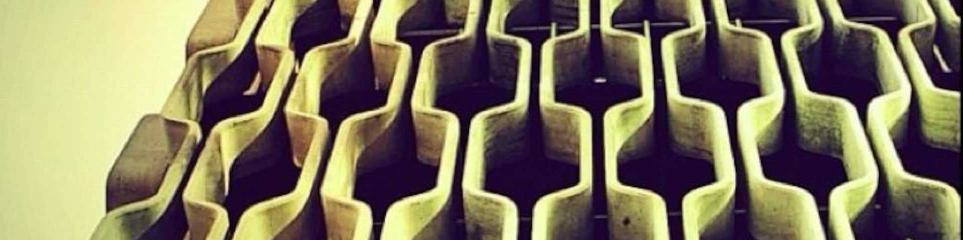 IBM Building (1962). Designed by Vladimir Ossipoff in 1962.  In a city filled with midcentury modern architecture The IBM Bldg stands apart as one of the most elegant examples. The concrete "grill" is meant to resemble both a typical Polynesian pattern and a computer punchcard.  It also serves the practical purpose of a sunscreen.  The unique shape makes it self-washing in the rain.