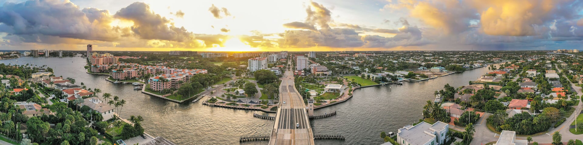 Boca Raton Florida Sunset. An aerial panoramic view over a drawbridge. Bright yellow and light blue colors in the sky.