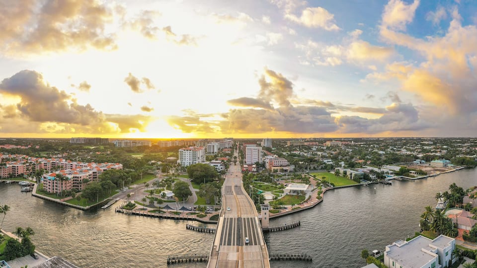 Boca Raton Florida Sunset. An aerial panoramic view over a drawbridge. Bright yellow and light blue colors in the sky.