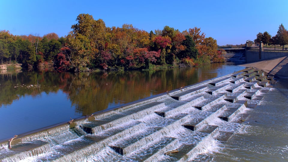 Water feature at White Rock Lake in Dallas Texas, tree lined with fall foliage.