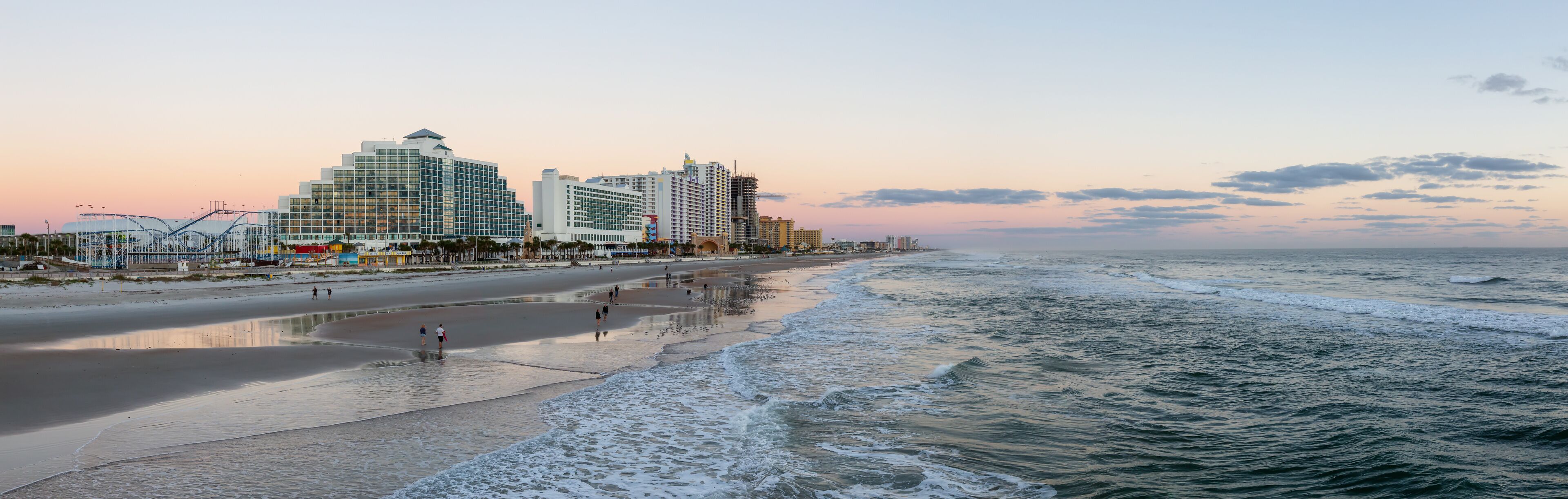 Daytona Beach, Florida, United States - October 31, 2018: Panoramic view of a beautiful sandy beach during a vibrant sunrise.