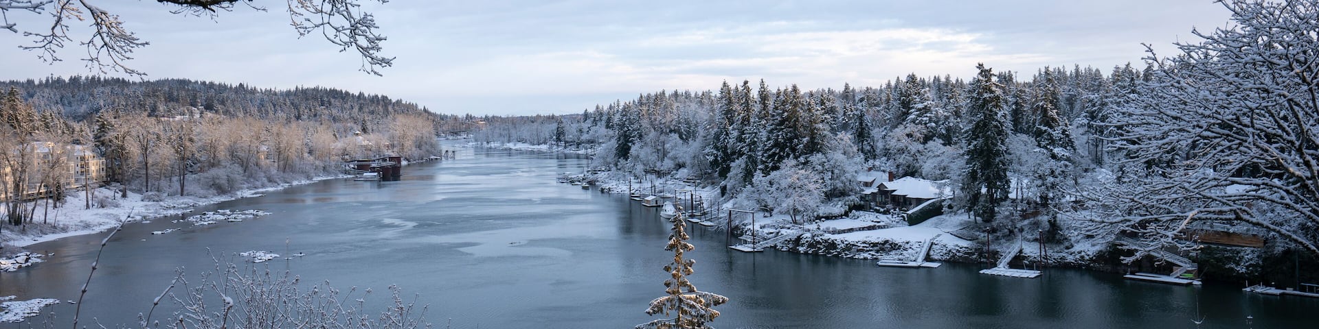 Willamette River viewed from the southern suburbs in the Portland metro area in Oregon on a cold winter morning after overnight snowfall.
