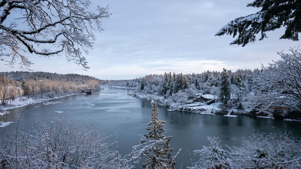 Willamette River viewed from the southern suburbs in the Portland metro area in Oregon on a cold winter morning after overnight snowfall.