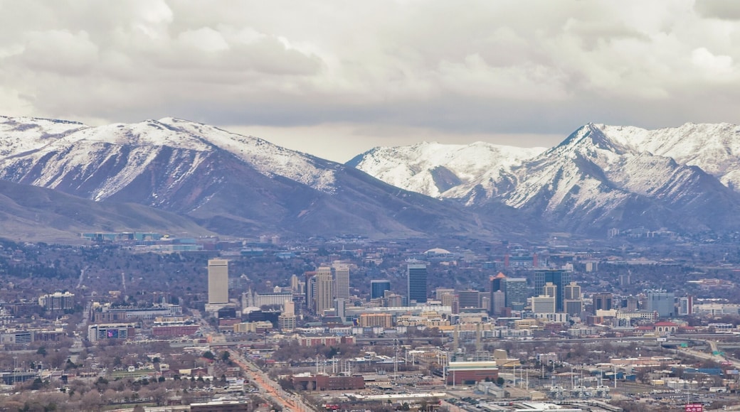 Downtown Salt Lake City Panoramic view of Wasatch Front Rocky Mountains from airplane in early spring winter with melting snow and cloudscape. Utah, USA.