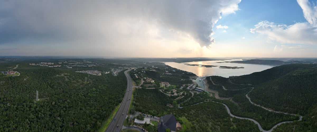Aerial view of Lake Travis and the Texas Hill Country during a passing thunderstorm at sunset.