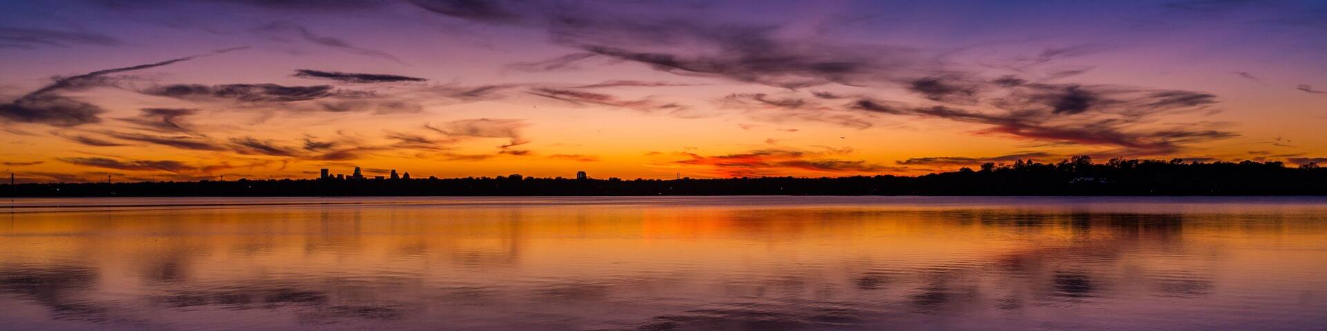 Vibrant sunset with a spectrum of colors at White Rock Lake in Dallas, Texas.