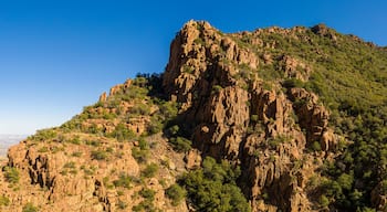 A panorama of a saddle in a mountain in Arizona from a drone with clear blue skies.